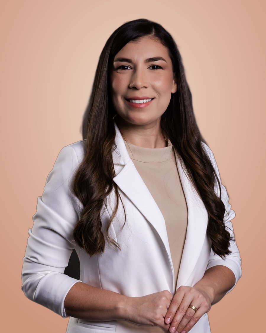 Dra. Leonoura Loiola Gomes sorrindo, de blazer branco